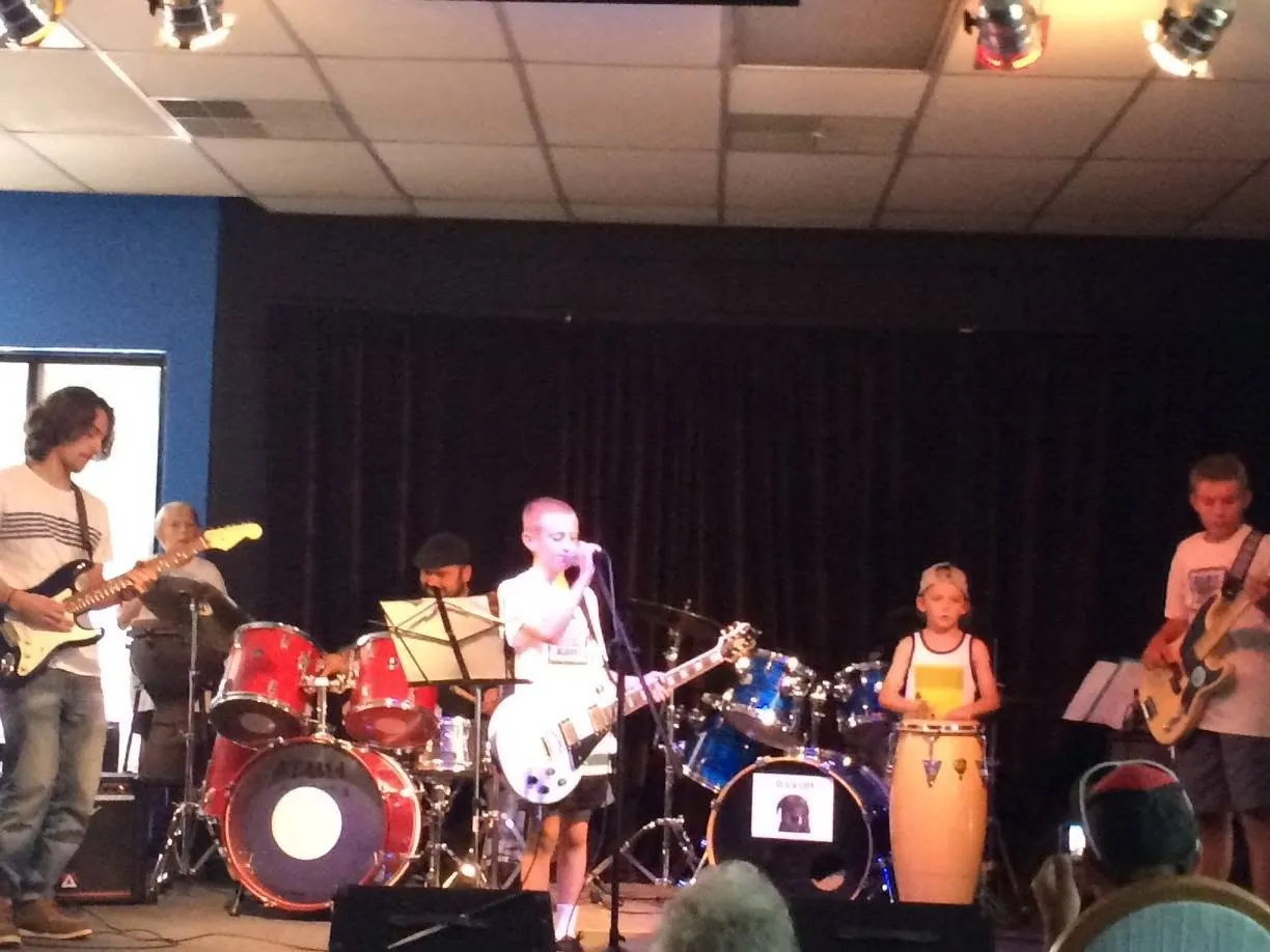 Mojo's Music Academy students performing together as a full band on stage