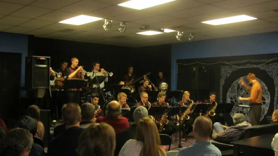 A band of Mojo's Music Academy students performing live on stage