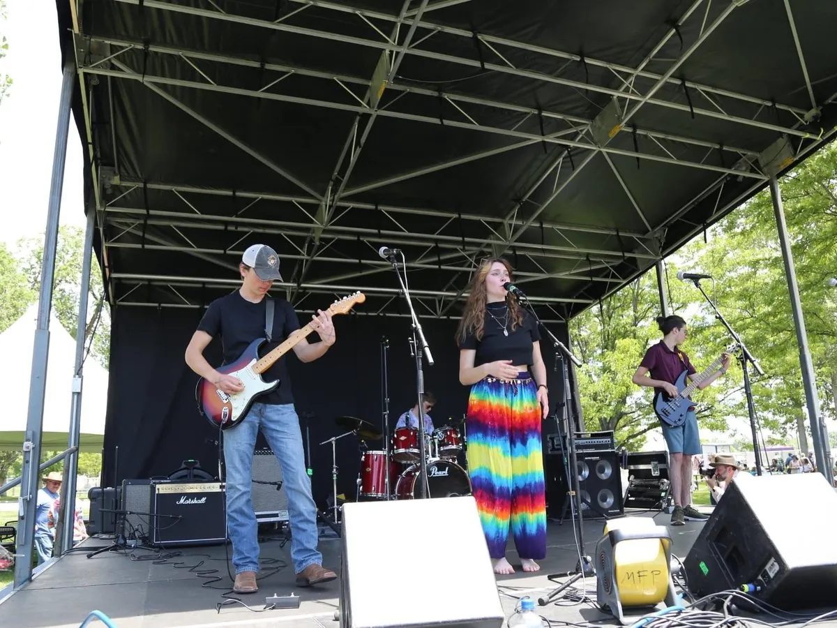 Dakota and Jasper Allison performing with their band on an outdoor festival stage