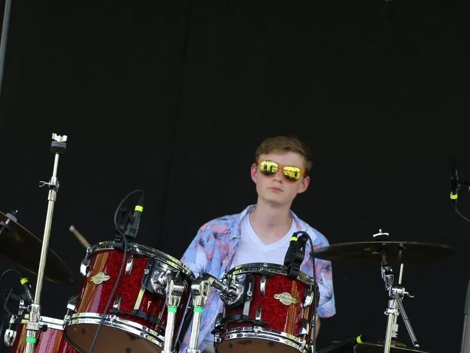Jasper Allison behind his drum kit at an outdoor festival