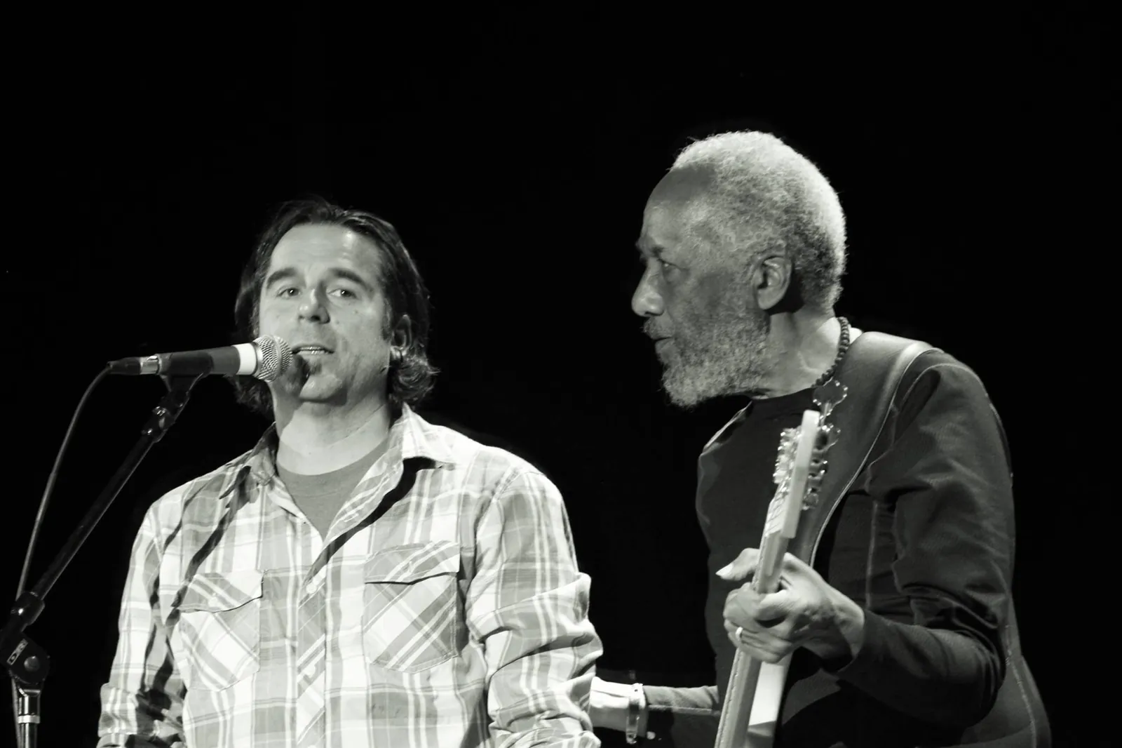 Paul Rogalski at the microphone beside bassist Chuck Rainey on stage at the Rocky Mountain Bass Slam