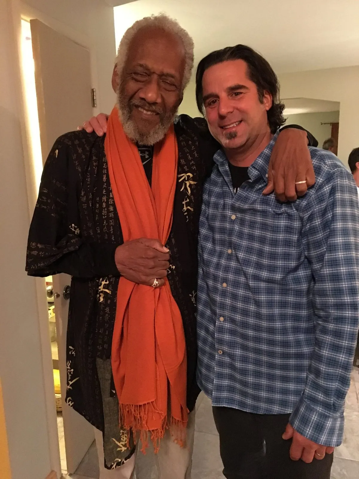 Paul Rogalski with his arm around bassist Chuck Rainey, both smiling