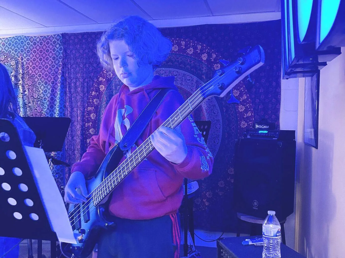 Student taking a bass guitar lesson in the studio at Mojo's Music Academy in Longmont, CO