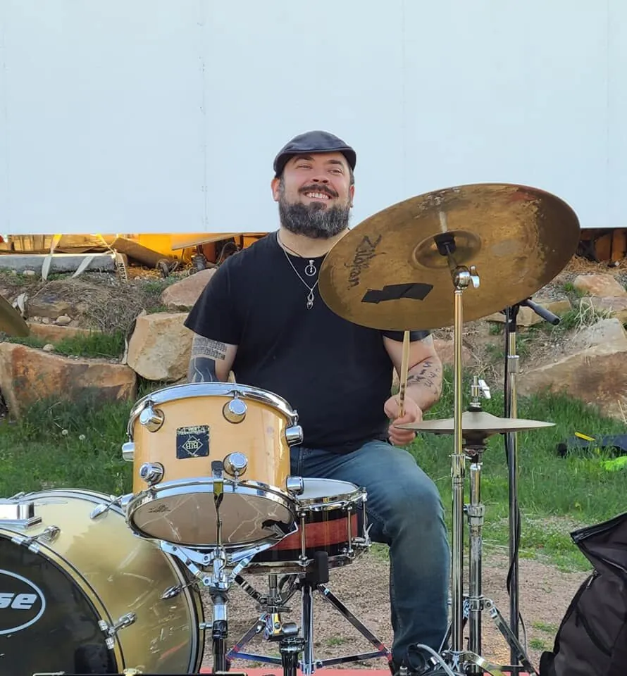 Paul Christiansen behind a drum kit, drum instructor at Mojo's Music Academy in Longmont, CO