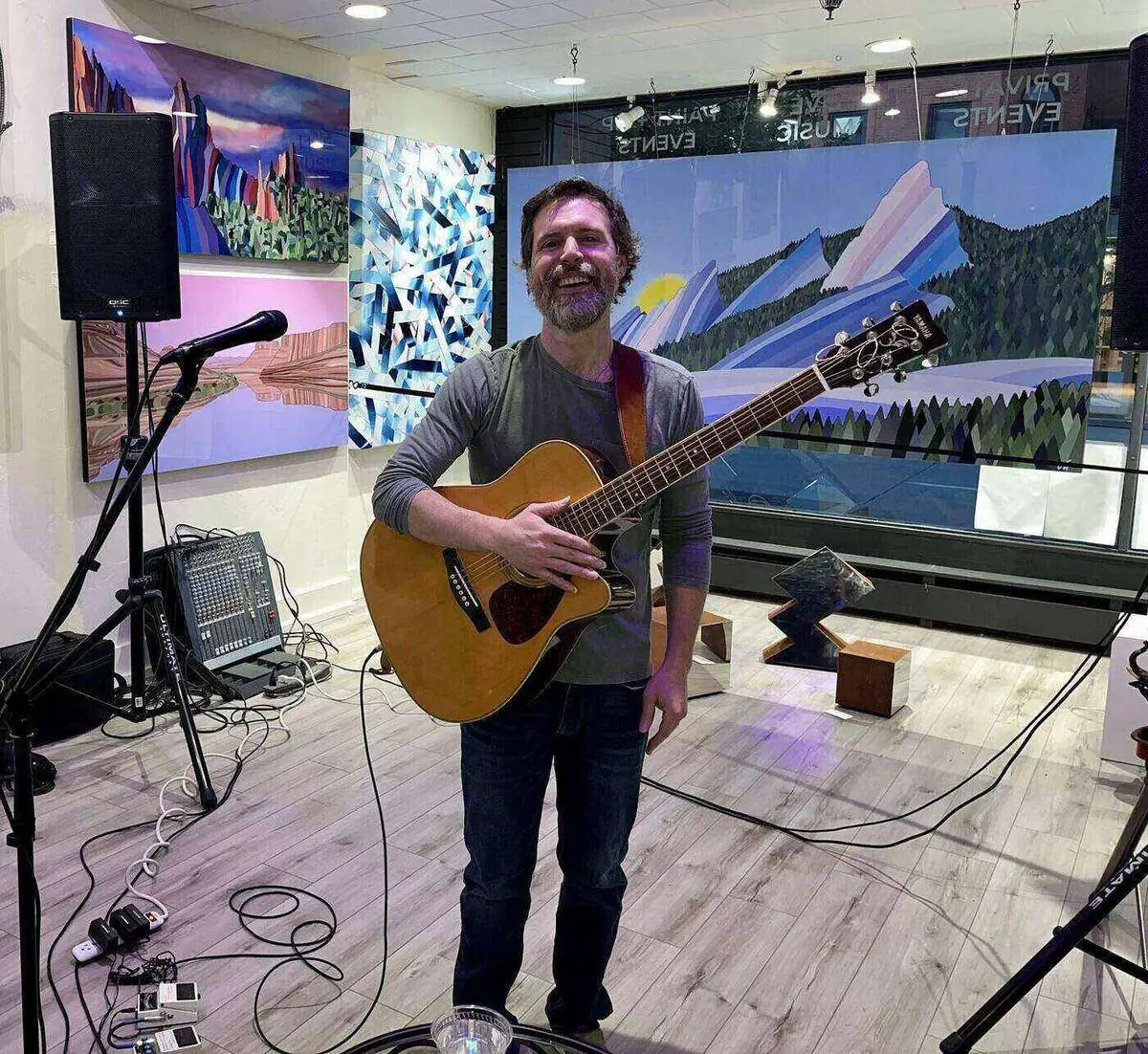 Shawn Cunnane holding an acoustic guitar, guitar instructor at Mojo's Music Academy in Longmont, CO